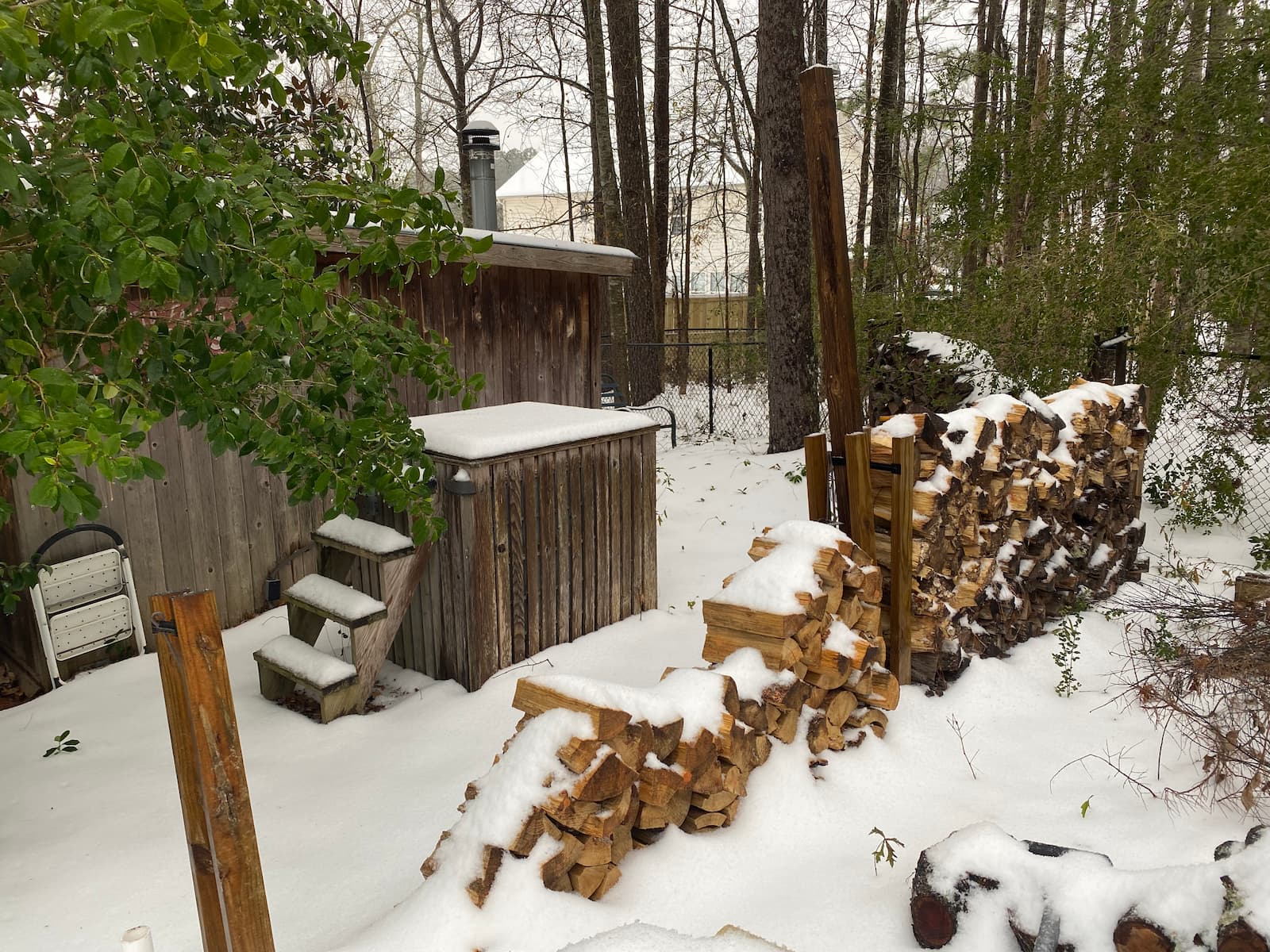 Stacked firewood in winter beside the banya